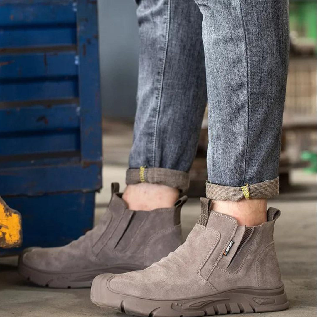 Side profile of brown men's safety work boots, highlighting robust construction & protective features.