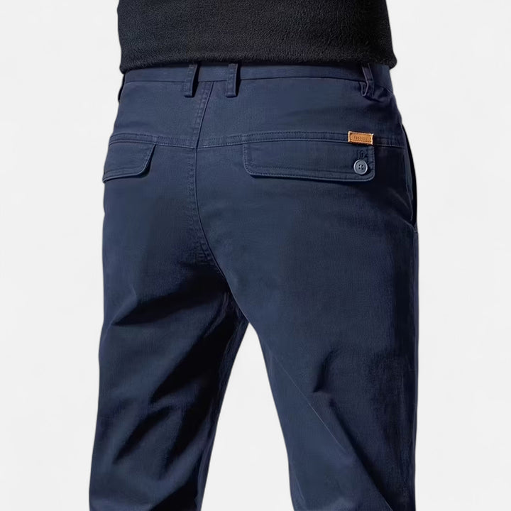 Close-up of the premium fabric on men's straight-leg tailored trousers, highlighting quality and texture.