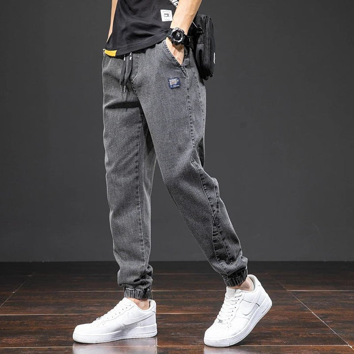 Stylish men's stretch denim joggers in dark wash, comfortable for everyday casual wear.