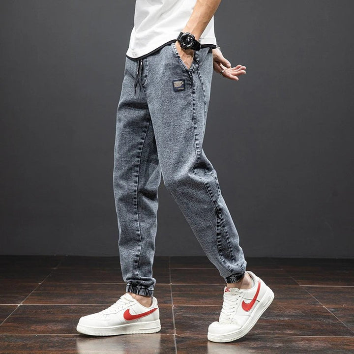 Men's cotton blend stretch denim joggers, elastic waist trousers for comfort and flexibility.