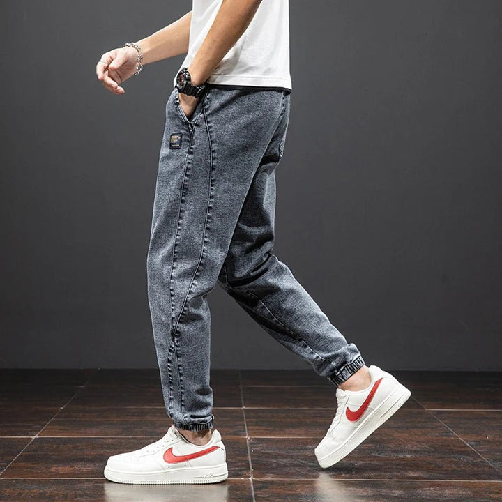 Versatile men's stretch denim joggers with comfort-fit elastic waist, perfect casual pants.