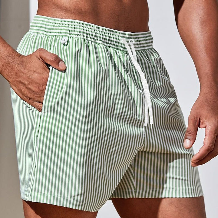 Comfortable men's striped beach shorts with a secure drawstring waist, suitable for all your summer swimwear needs.