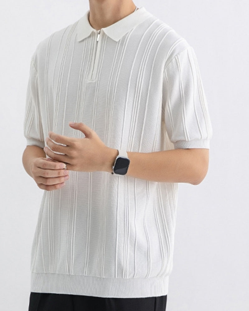 Close-up of stylish men's half-zip polo, featuring a crisp striped pattern and ribbed knit collar.