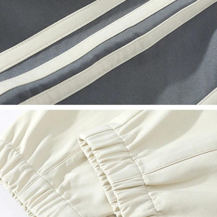 Man relaxing in a comfortable striped loungewear tracksuit, perfect two-piece set for home.