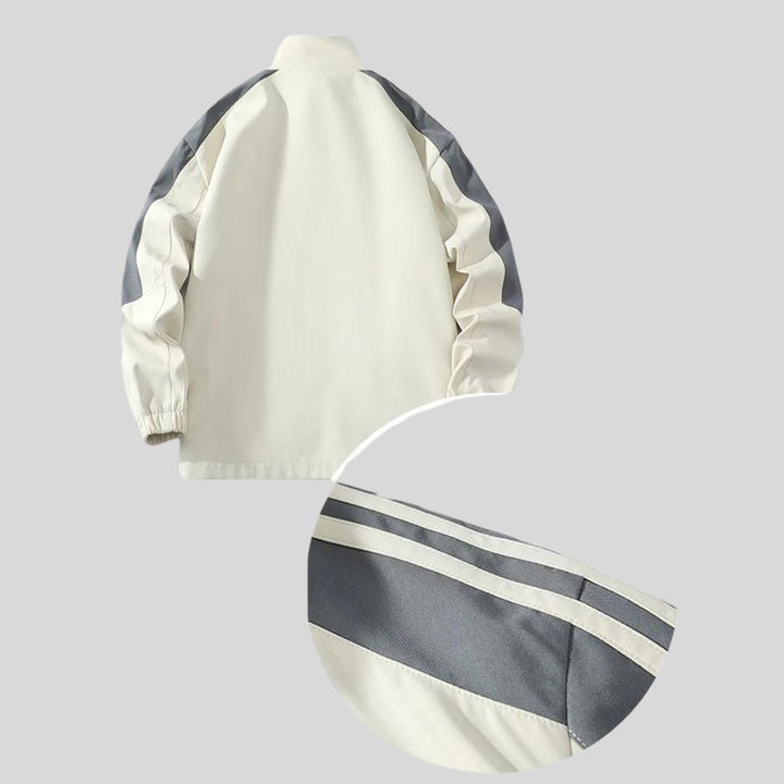 High-quality detail of collar/cuff on men's striped sports tracksuit, premium athletic apparel.