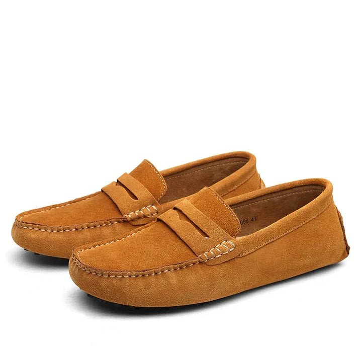 Side view of men's elegant black slip-on loafers. Stylish & comfortable driving shoes for casual or smart-casual wear.
