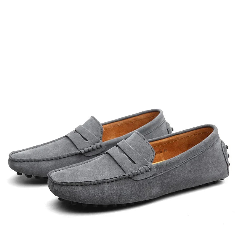 Man wearing comfortable brown leather driving loafers. Stylish slip-on shoes perfect for casual outings or driving.