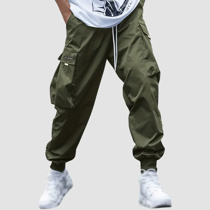 Modern tapered fit men's cargo pants in a versatile color, ideal for all-season casual fashion.
