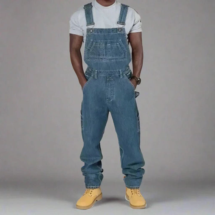 Fashionable men's denim overalls, versatile for streetwear or casual outfits, with comfortable adjustable straps.