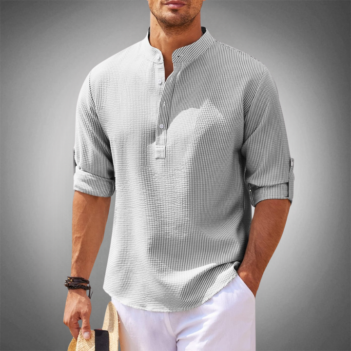Versatile men's long sleeve button-down shirt in a neutral color, ideal for modern gentlemen's spring style.