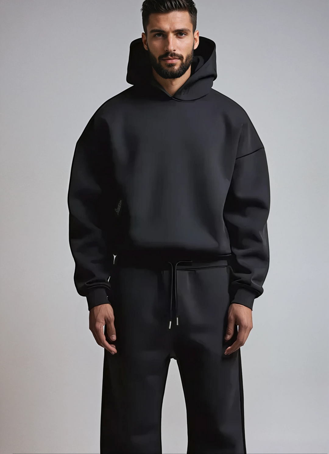 Modern fit men's streetwear tracksuit set, featuring a stylish hoodie and joggers for versatile fashion.