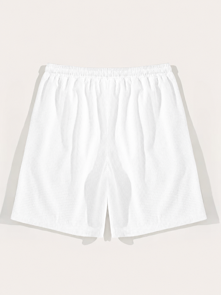 Comfortable men's casual shorts, textured with a drawstring. Essential relaxed fit summer beachwear.