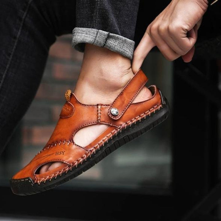 Stylish men's open-toe sandals with adjustable strap & cut-out details. Ideal for vacation, beach, or casual summer.