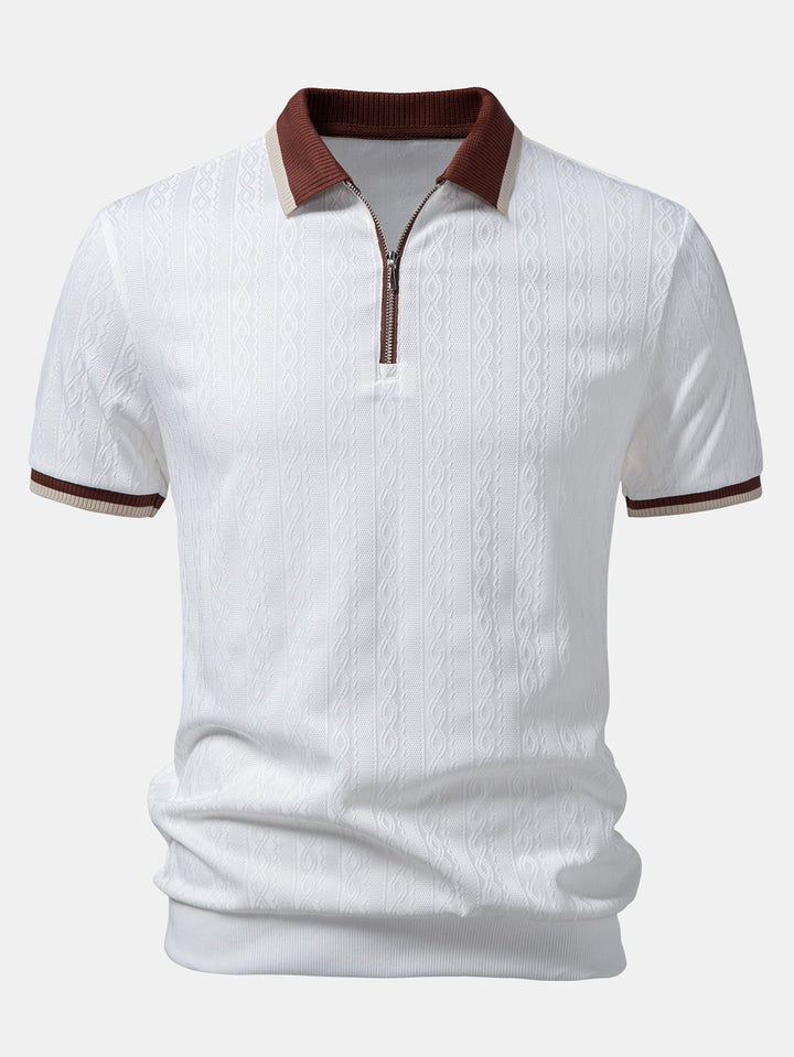 Close-up of men's textured knit quarter-zip polo. Tailored fit short-sleeve top for refined everyday wear.