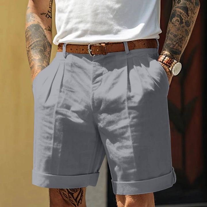 Navy blue men's tailored pleated summer shorts with a refined fit & stylish turn up hem detail.