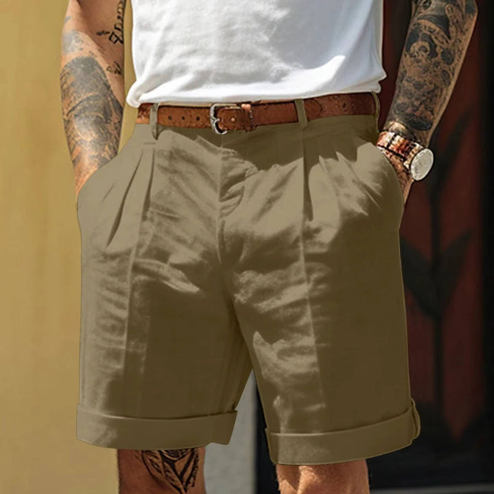Olive green men's tailored pleated shorts. Features refined fit, turn up hem, perfect for summer style.