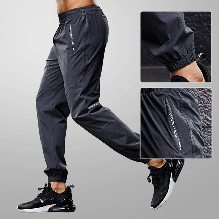 Men's tapered fit jogger pants with zipper pockets, ideal for athletic training & casual wear.
