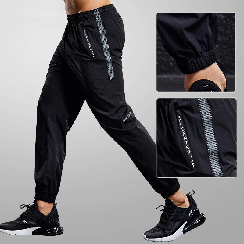 Lightweight, quick-dry men's jogger pants. Comfortable, tapered fit activewear with secure zipper pockets.