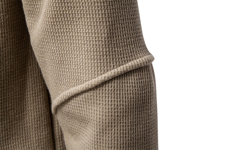 Long sleeve men's textured henley top, a comfortable sweatshirt for versatile styling.