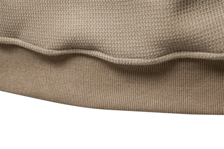 Stylish men's textured henley sweatshirt, perfect for layering in autumn and winter.