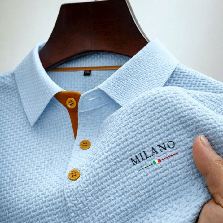 Close-up of men's textured polo shirt with stylish button placket & contrast buttons, perfect for modern casual wear.