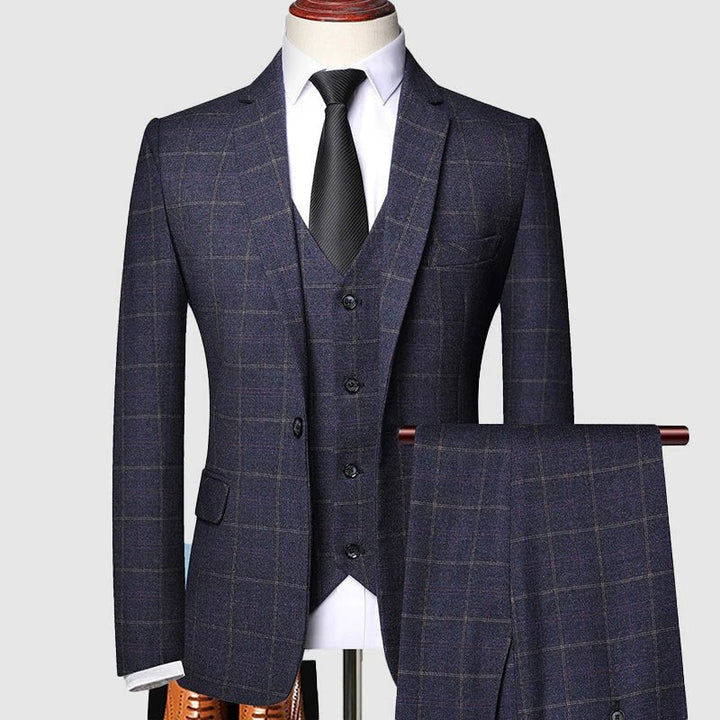 Men's three-piece checked formal suit, tailored for a sharp, sophisticated look. Perfect for business or weddings.