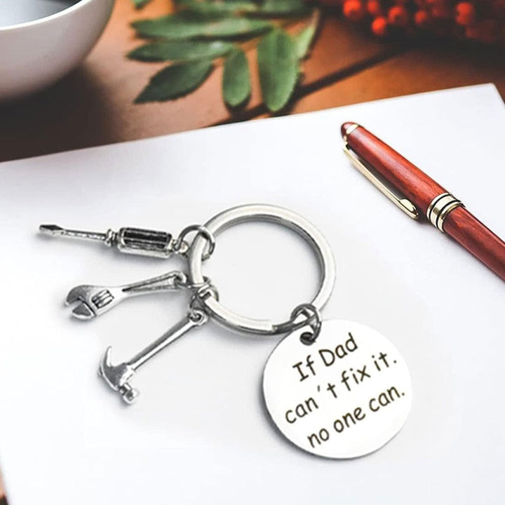 Detailed tool charms keychain featuring mini hammer, wrench, saw. A durable, novelty gift for craftsmen & DIYers.