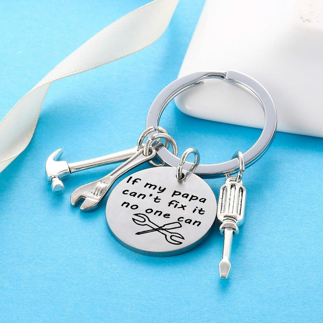 Unique men's tool keychain with multiple metal charms like a hammer, wrench, and saw. Perfect handyman gift idea.