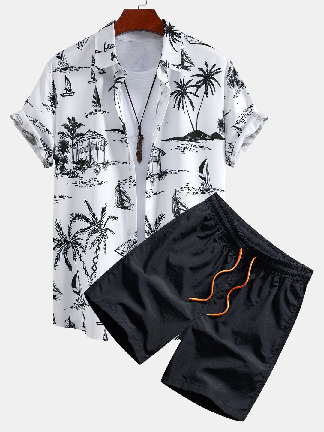 Stylish men's palm print short-sleeve shirt and coordinating swim shorts for a casual summer look.