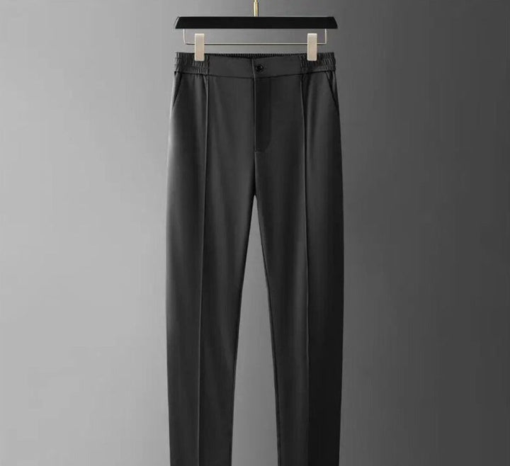 Trendy men's two-piece polo & tapered pants set, essential for stylish spring/summer fashion.