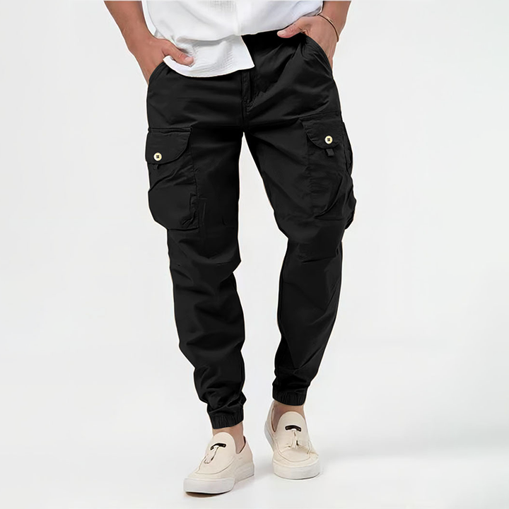 Functional men's streetwear joggers, cargo style with spacious pockets & elastic cuffs, great for urban exploration.