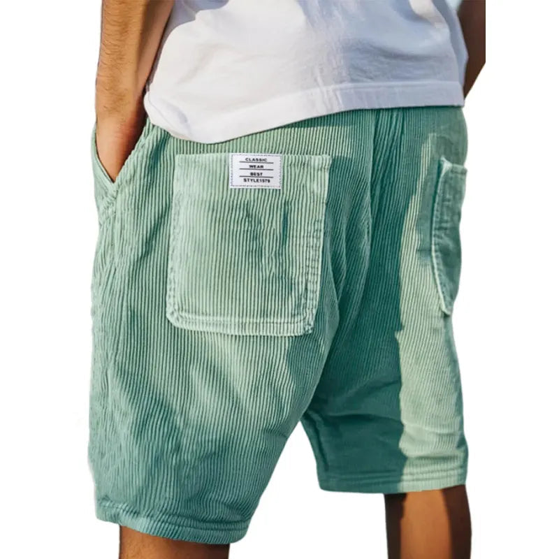 Stylish men's urban casual shorts featuring an elastic waistband & patch pocket, ideal for summer streetwear.