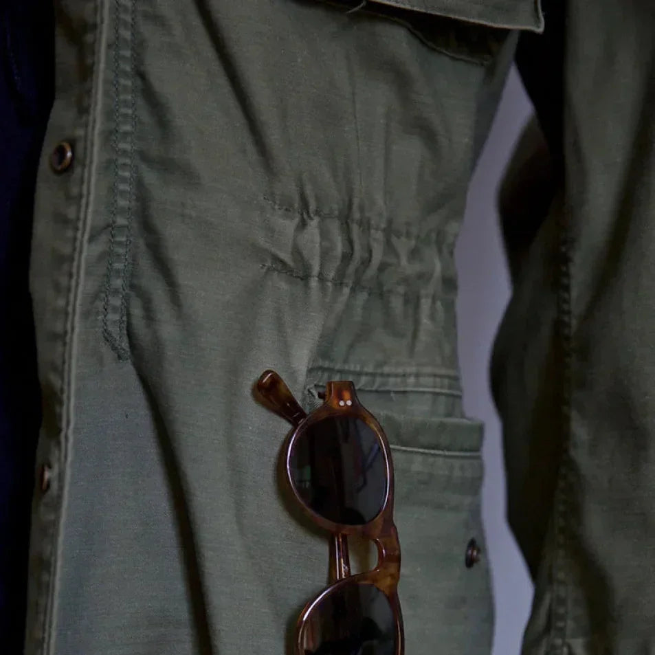 Rugged men's field jacket for adventure. Long sleeve utility outerwear with practical multi-pockets in military style.