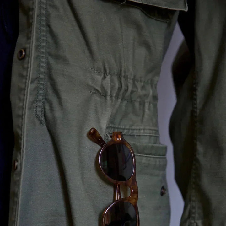 Rugged men's field jacket for adventure. Long sleeve utility outerwear with practical multi-pockets in military style.