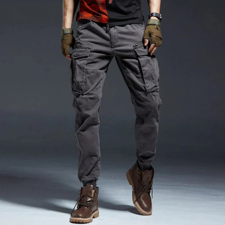 Relaxed fit black men's cargo pants with multi-pockets, elastic waist, perfect for versatile outdoor use.