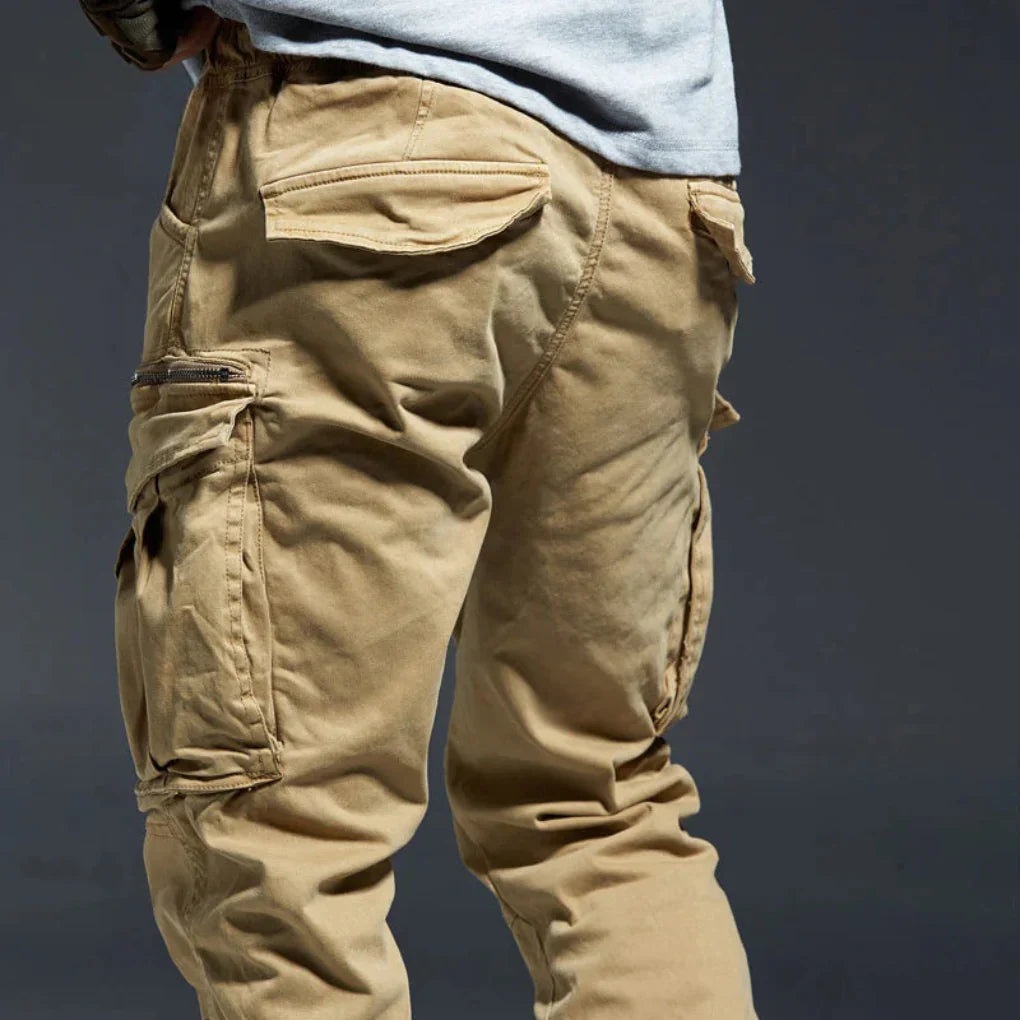 Versatile men's multi-pocket cargo pants, elastic waist, ideal for outdoor activities & everyday wear.
