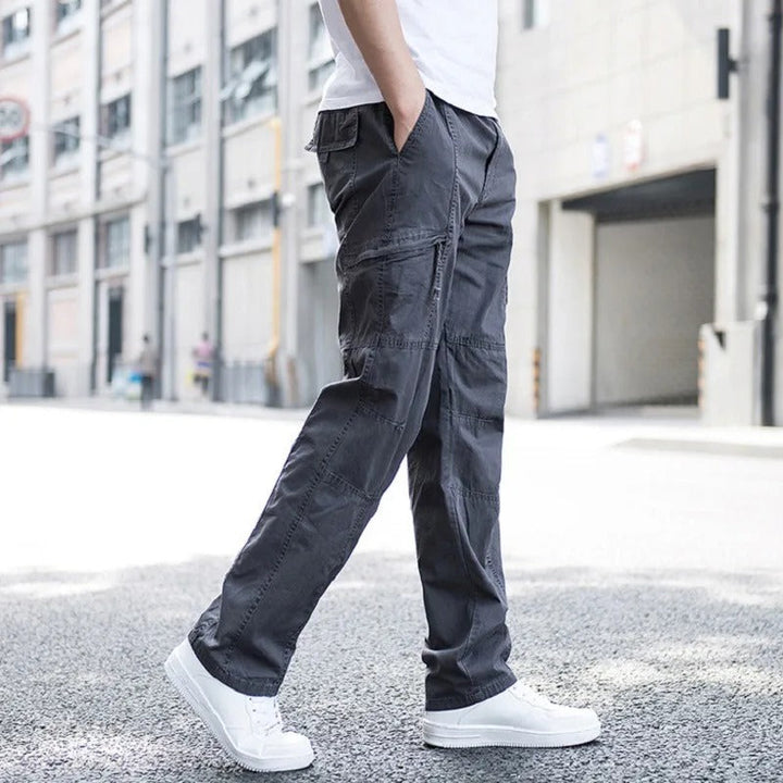 Man wearing comfortable men's cargo pants, relaxed fit, perfect for versatile everyday & outdoor activities.