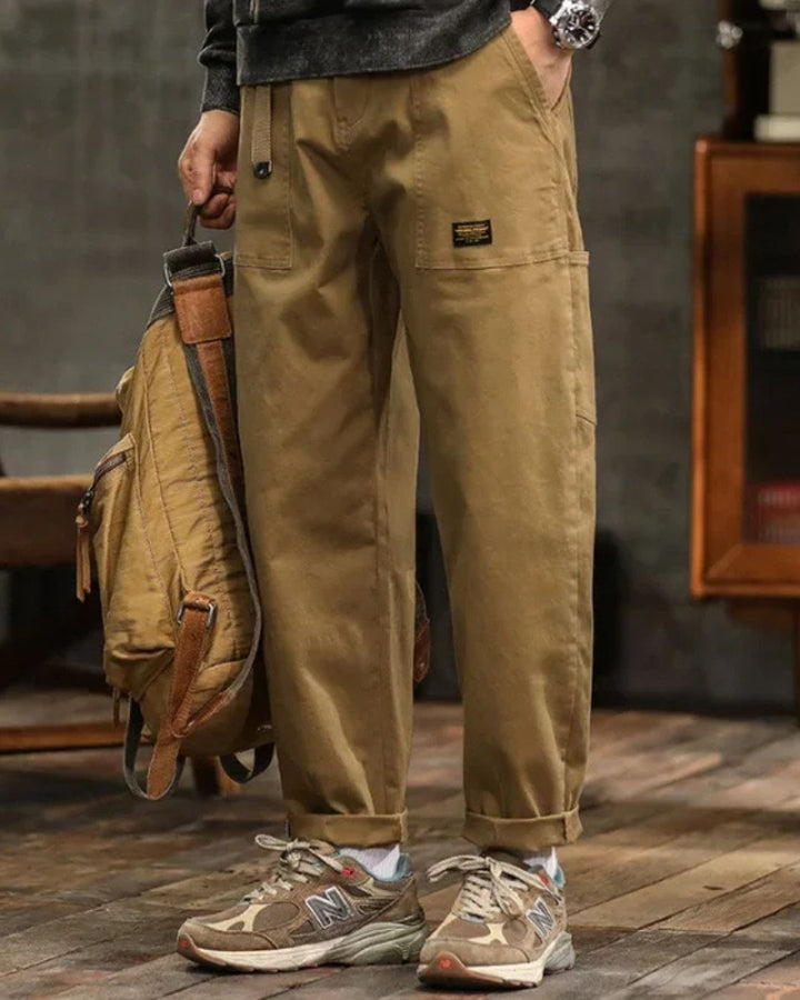 Black men's vintage cargo pants with large utility pockets, relaxed fit streetwear trousers for a rugged look.