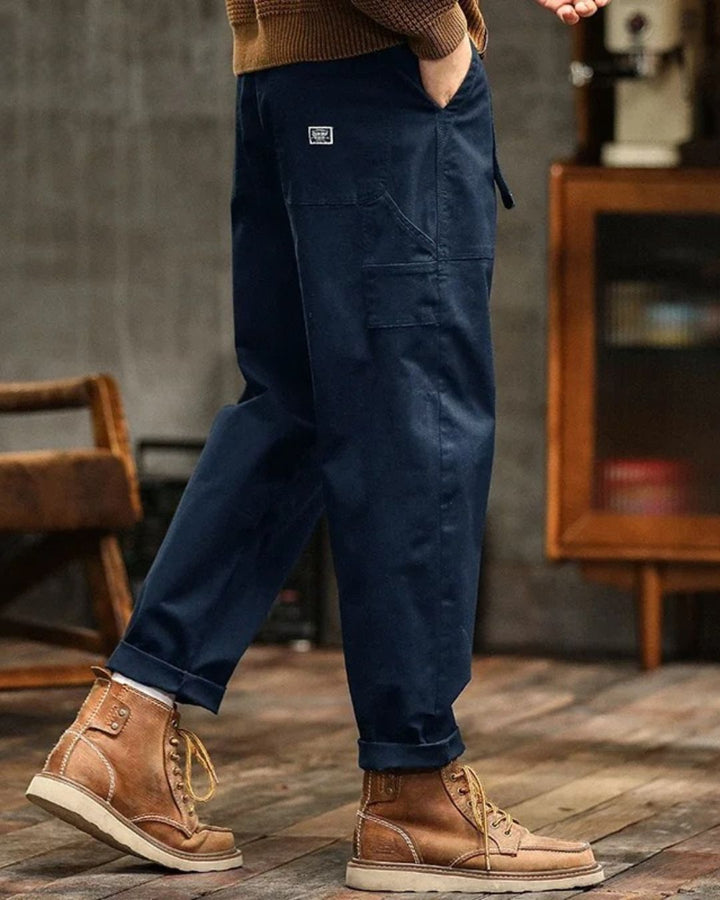 Army green relaxed fit men's vintage cargo pants, durable utility trousers with ample pocket storage, streetwear style.