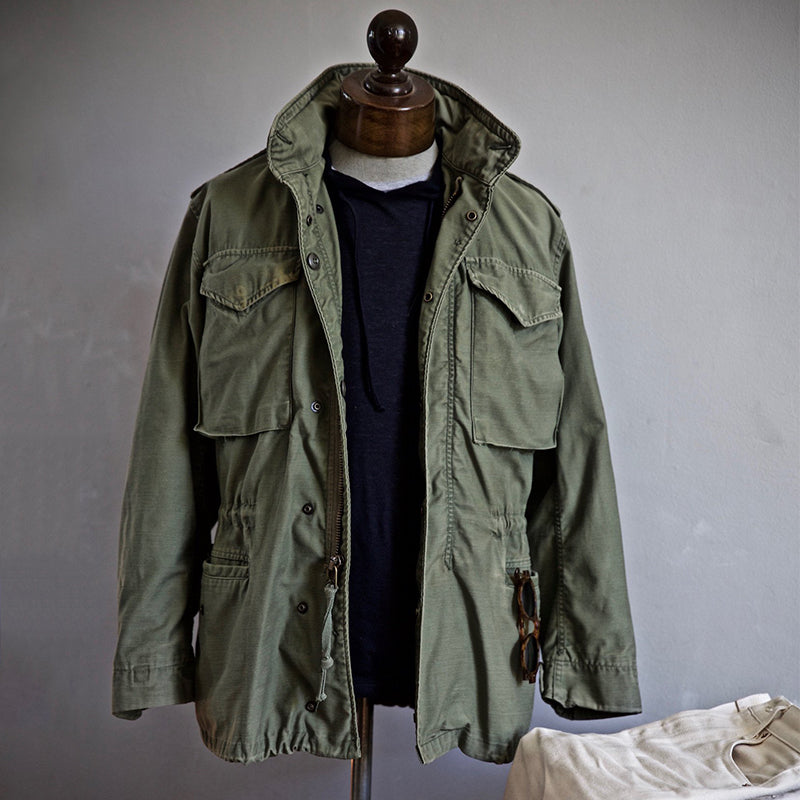 Men's vintage military jacket with hidden hood, cargo pockets, and rugged style. Perfect casual outerwear.
