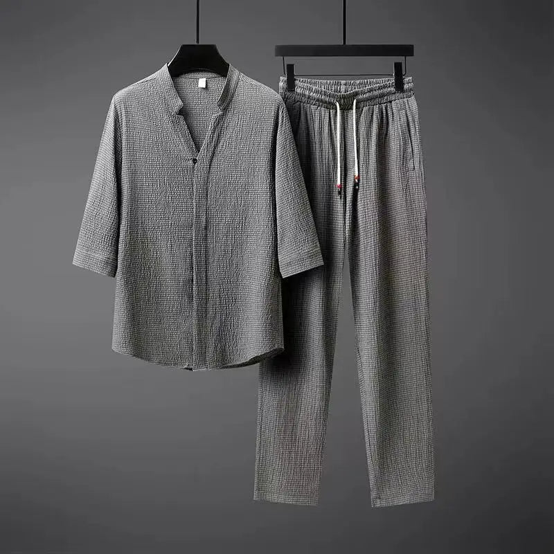 Men's vintage style black two-piece tracksuit set with button-down top & elastic waist pants for casual spring wear.