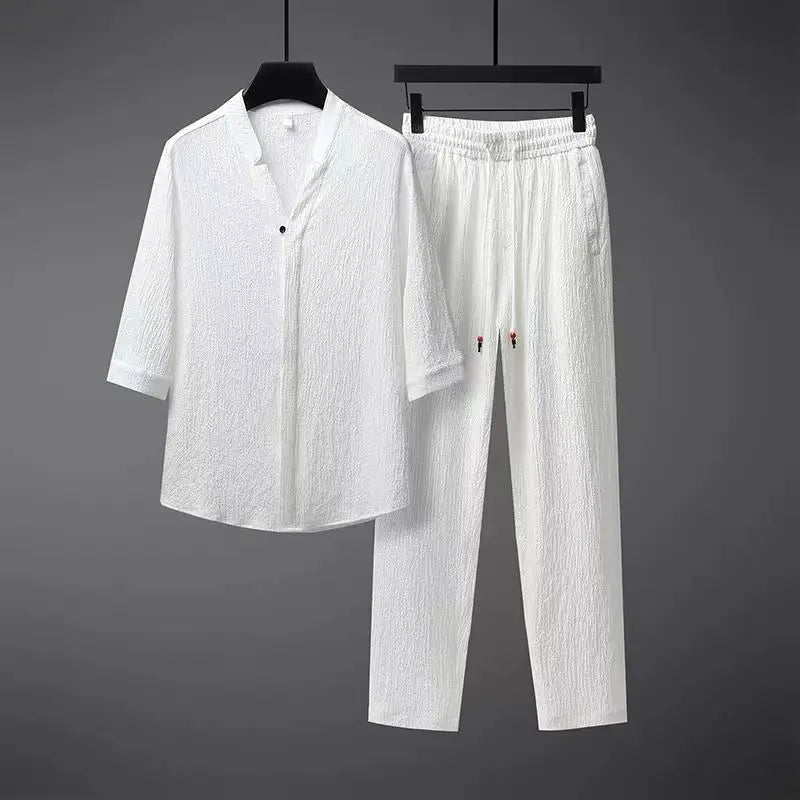 Stylish men's two-piece vintage tracksuit featuring a button-down shirt & elastic waist pants for spring fashion.