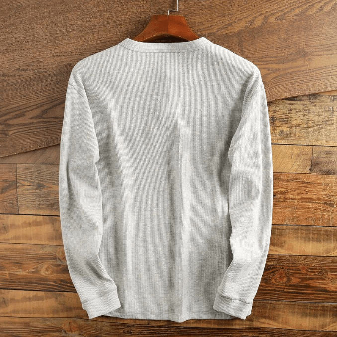 Textured men's waffle knit henley, long sleeve casual top. Stylish and versatile men's fashion apparel.