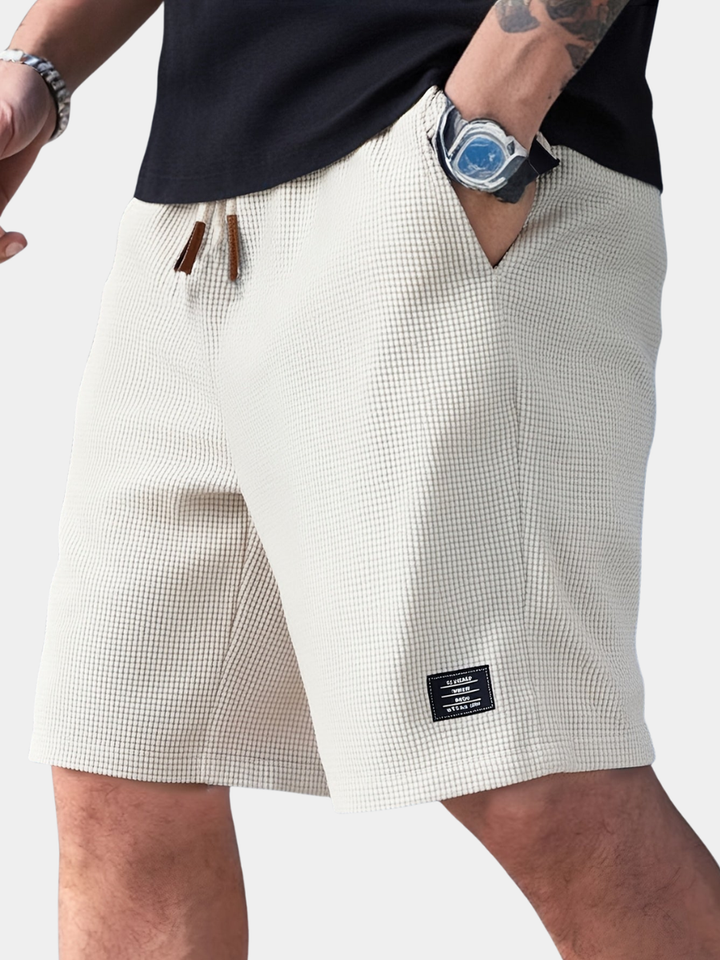 Close-up of men's waffle texture shorts fabric. Lightweight & soft, perfect for summer wear.