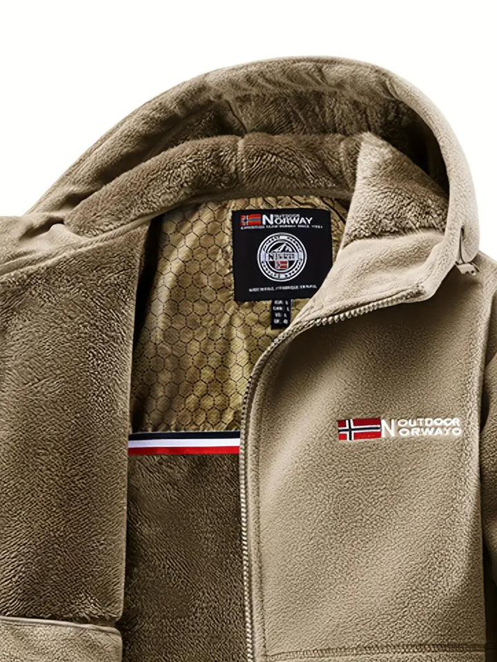 Man hiking in a warm, durable winter jacket, perfect for cold weather outdoor adventures.