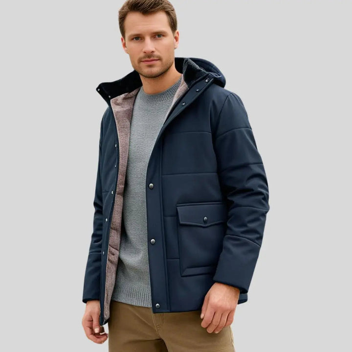 Textured close-up of a men's durable outdoor winter jacket, featuring weather-resistant fabric & thick insulation.