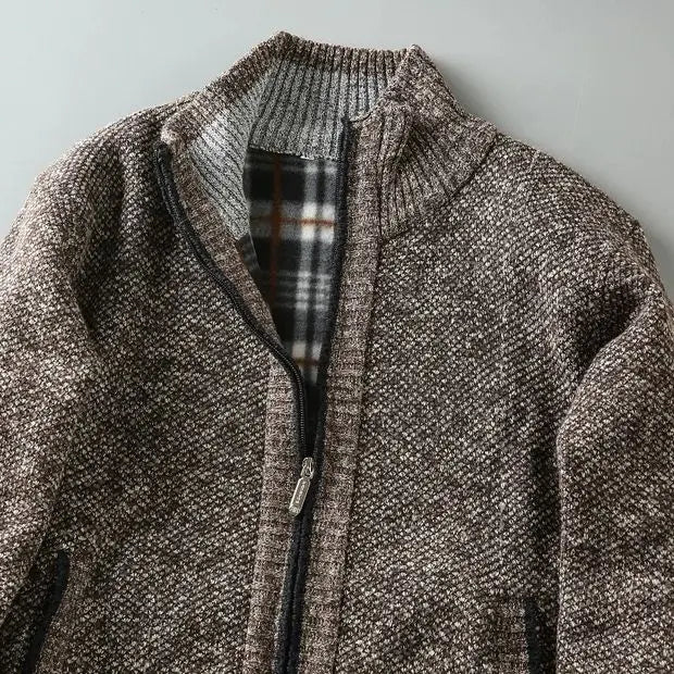 Close-up of a men's stylish knit zip-up jacket, showcasing soft fleece lining & knit texture.