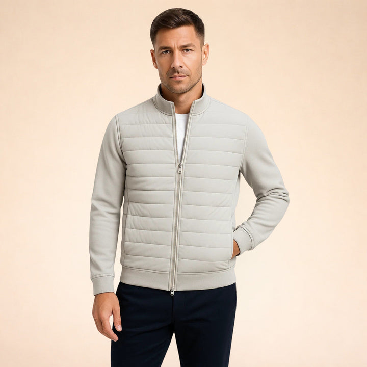 Lightweight men's hybrid jacket with quilted body and flexible stretch knit sleeves for ultimate comfort & warmth.