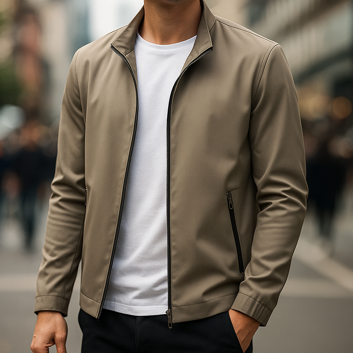 Model wearing a black men's water-resistant zip jacket, a versatile lightweight option for daily transitional wear.