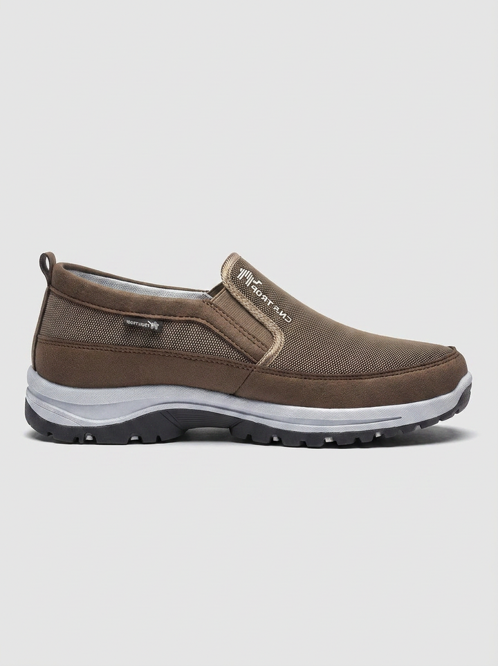 Side view of men's casual waterproof slip-on shoes, featuring orthopedic support & elastic panels for easy wear.